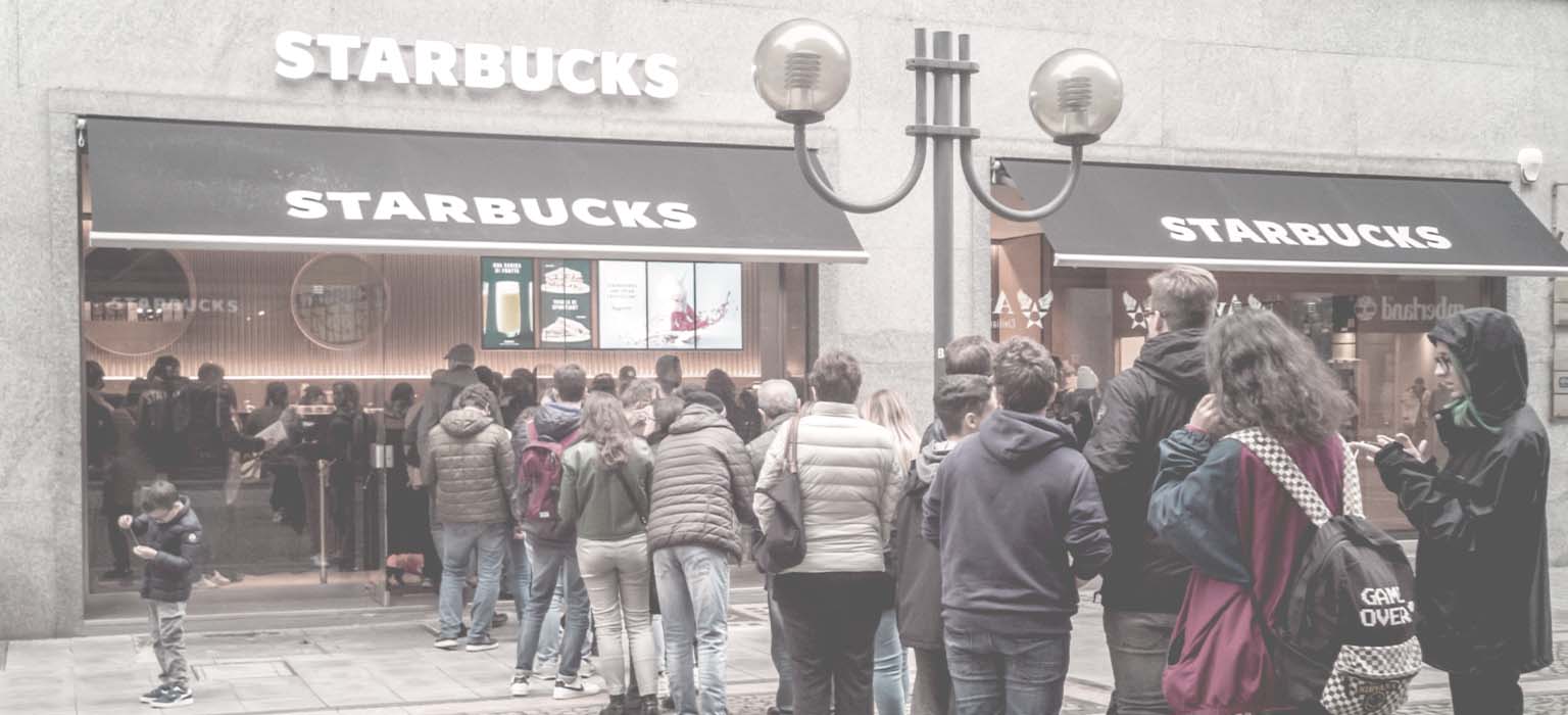 A long line outside of a Starbucks store