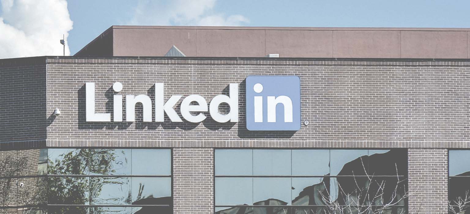 The LinkedIn sign hangs on a building exterior 
