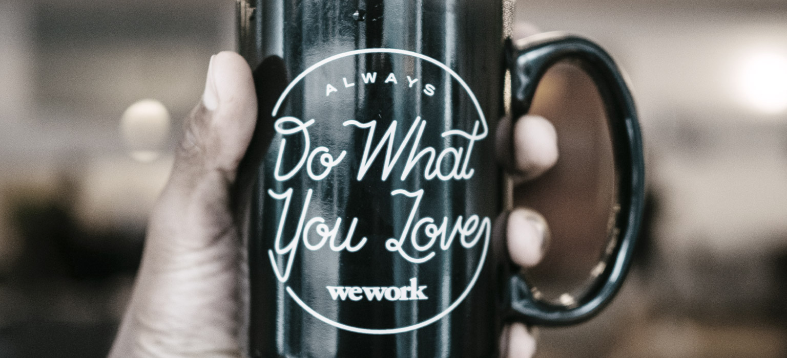 WeWork's tagline, "Do What You Love" is emblazoned on a mug